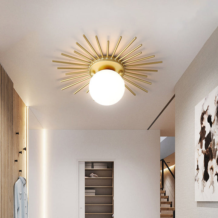 Elegant gold flush mount ceiling lamp. Features a spherical frosted glass design for modern lighting.