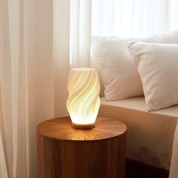 Ambient light from a dimmable Wavecrest lamp, elegant wave design, perfect for decor.