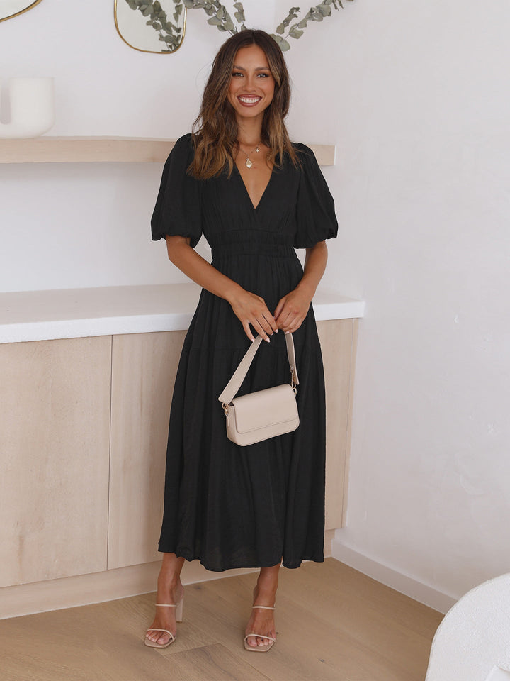 Feminine women's elegant midi dress featuring stylish puff sleeves for summer style.