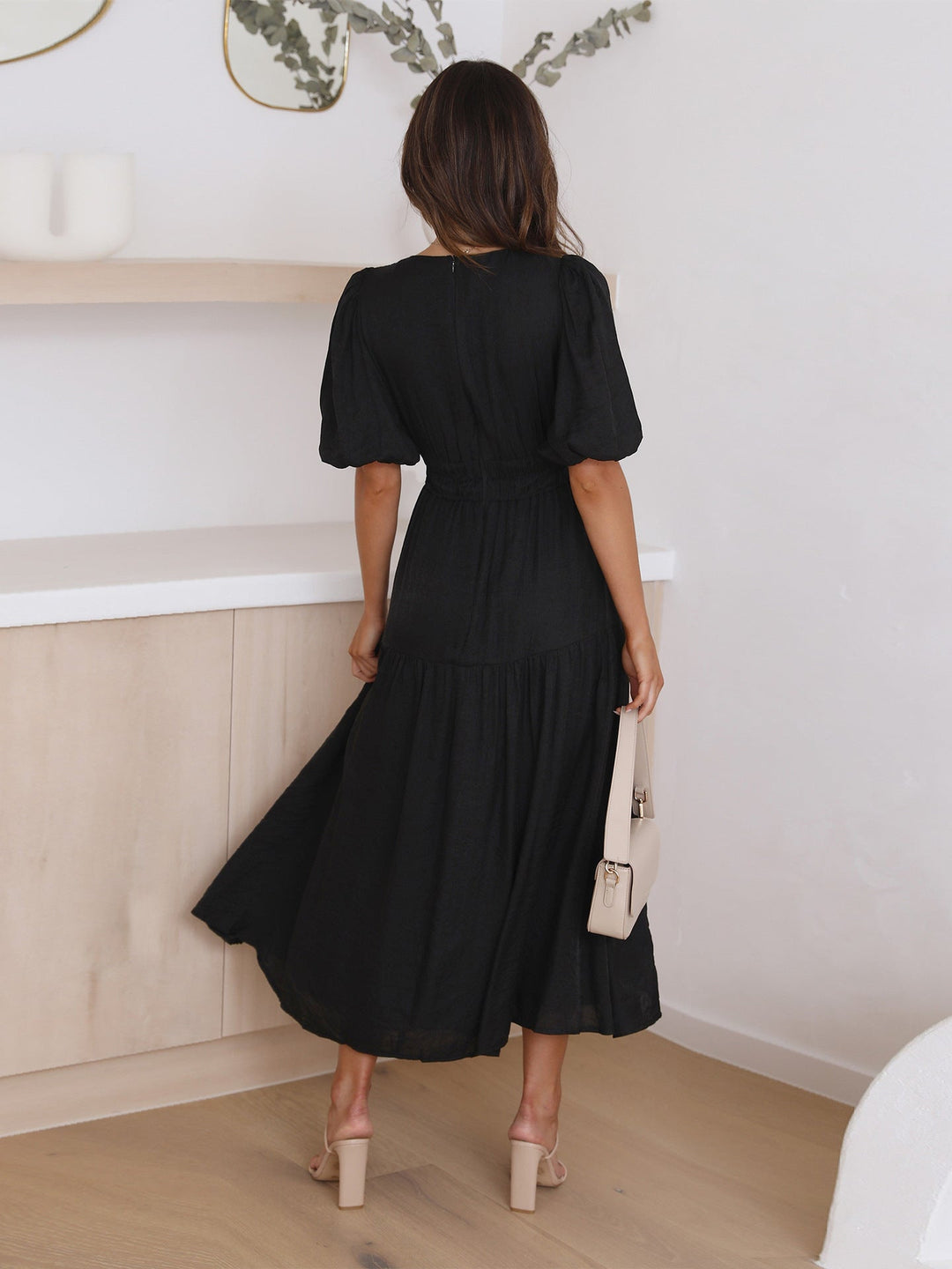 Timeless women's dress with delicate puff sleeves and a flattering midi length, spring fashion.