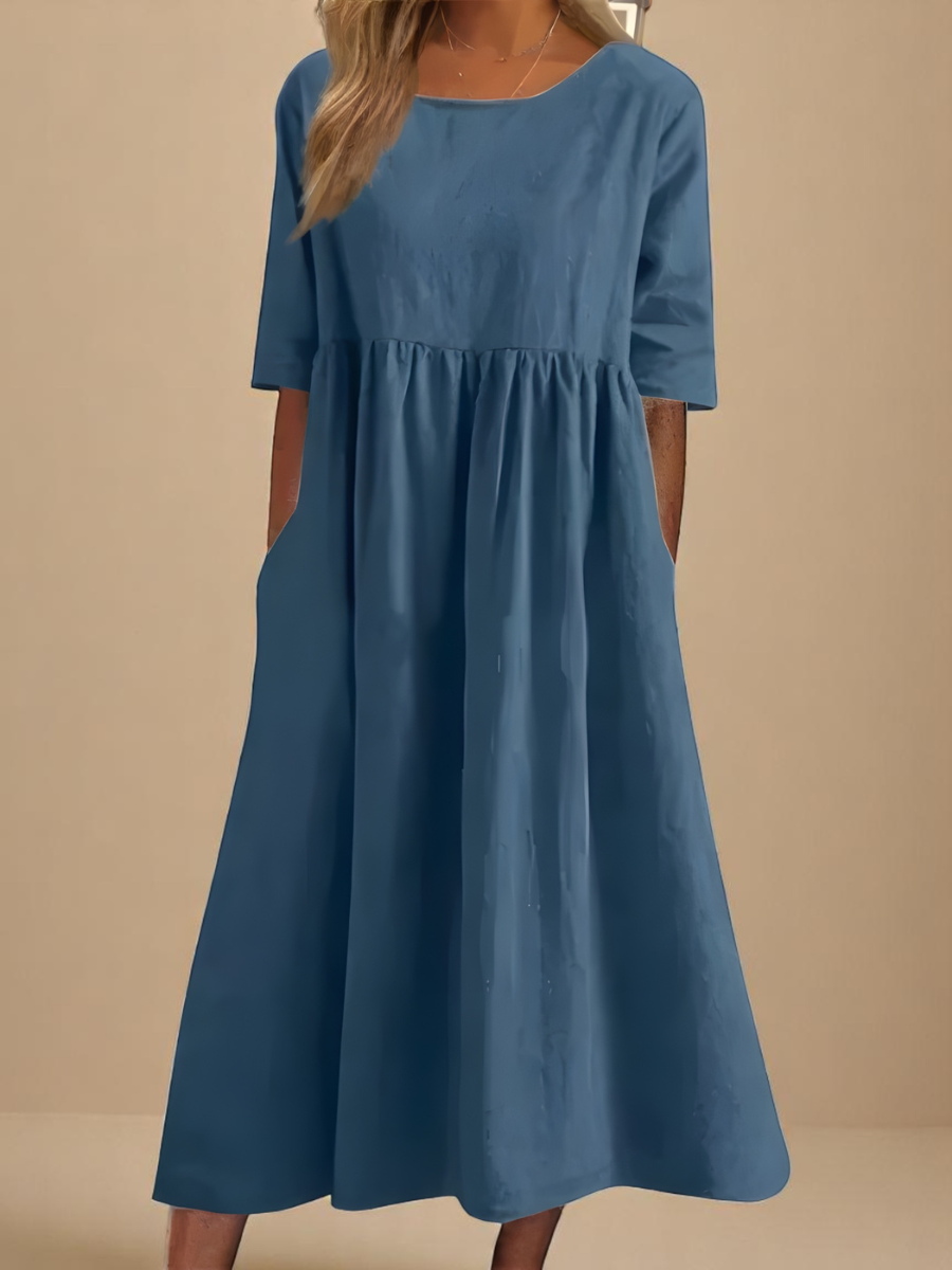 A woman wearing a classic mid-sleeve round neck dress with pockets, perfect for casual everyday wear.