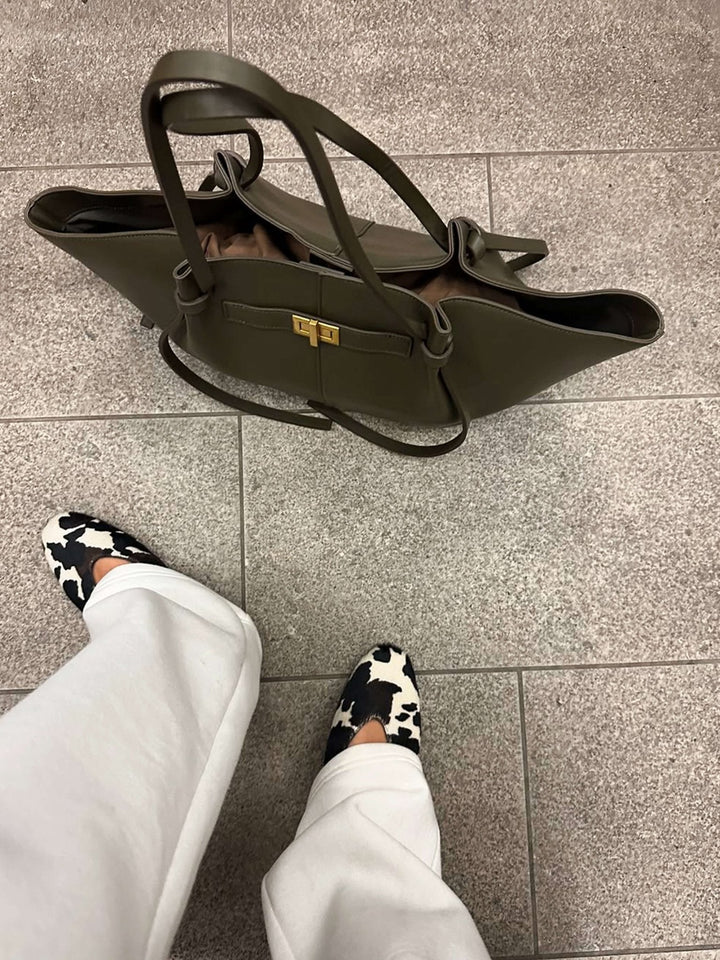 Women's Verona Structured Bag held by hand, demonstrating its comfortable and chic handbag style.