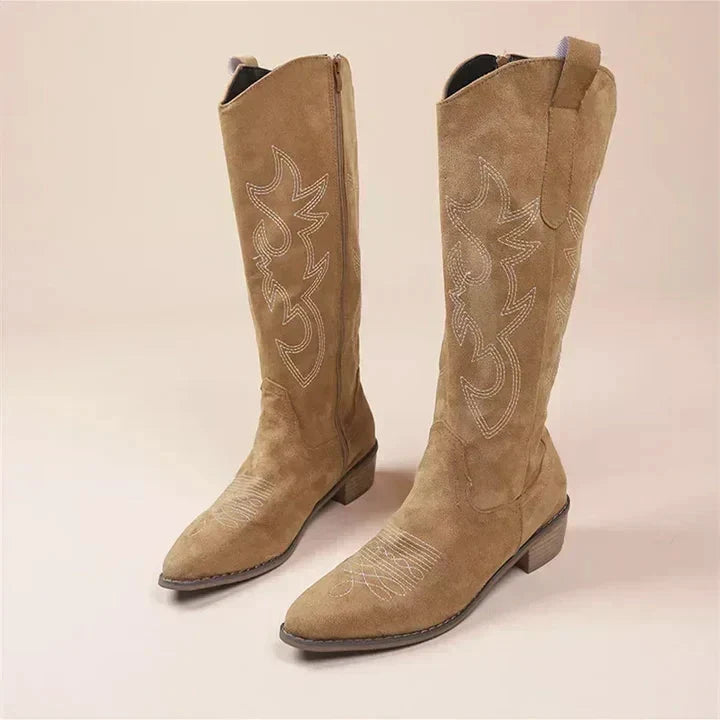 Close-up of women's stylish embroidered cowboy boots. Pointed toe Western footwear for casual autumn fashion.
