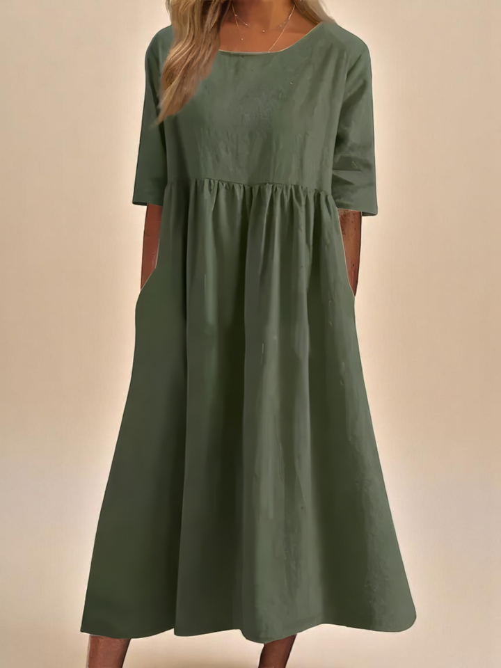 Elegant women's classic mid-sleeve dress, featuring a round neck and convenient pockets, for effortless style.