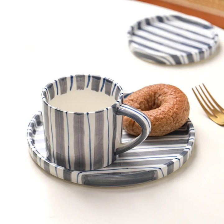 Vintage style hand-painted ceramic cup & saucer set, an elegant gift for coffee lovers or kitchen decor.