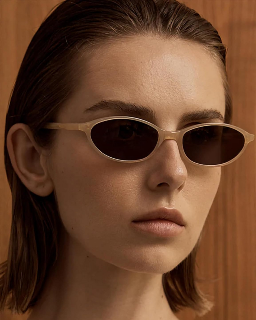 Women's chic black oval sunglasses with a modern 90s retro design, perfect fashion eyewear.