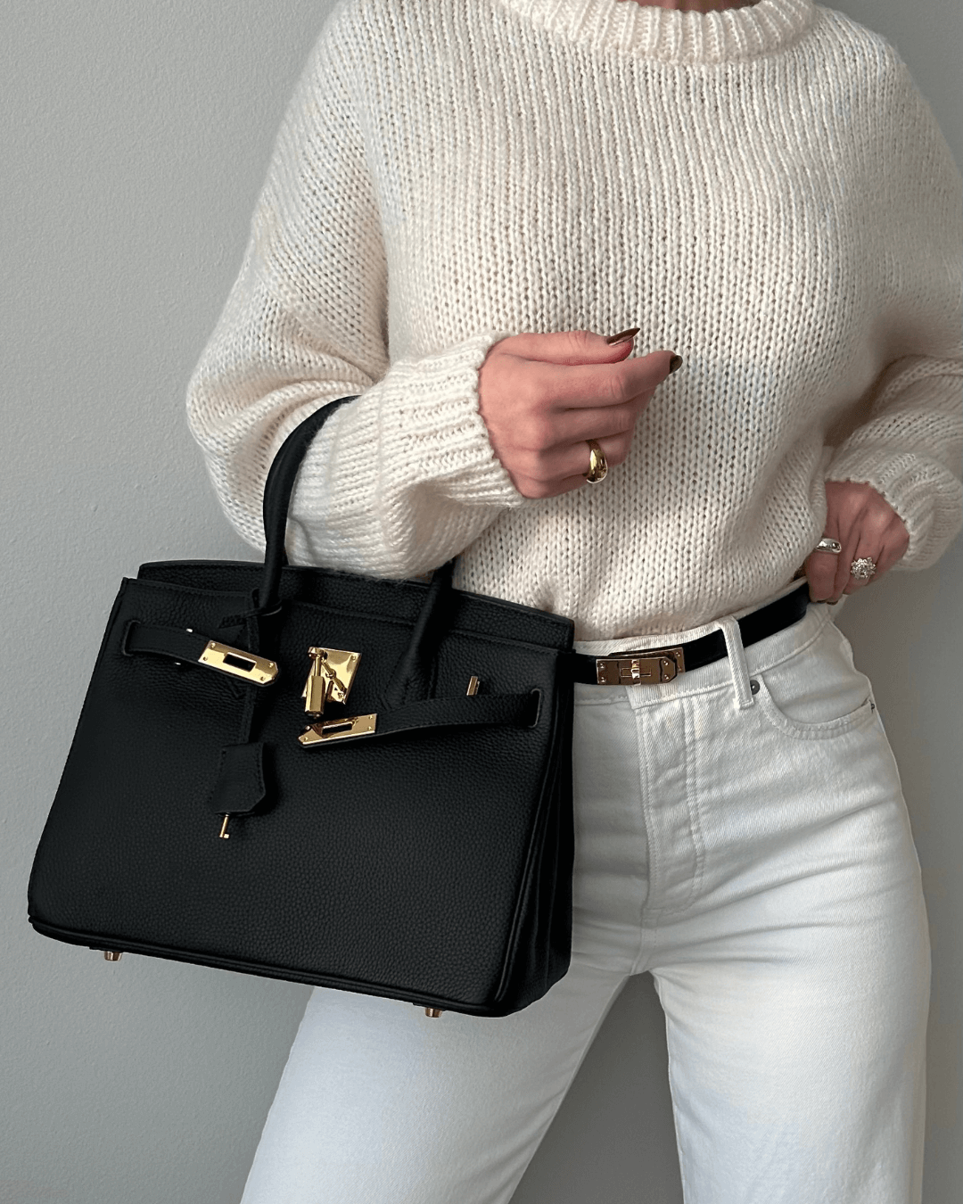 Luxury women's shoulder bag: intricate embossed leather and gleaming golden hardware details.