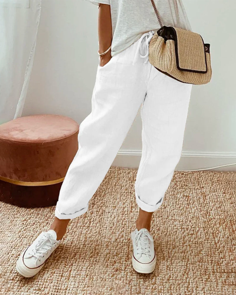Relaxed women's casual tapered pants, adjustable drawstring, loose fit high waist trousers for comfort.