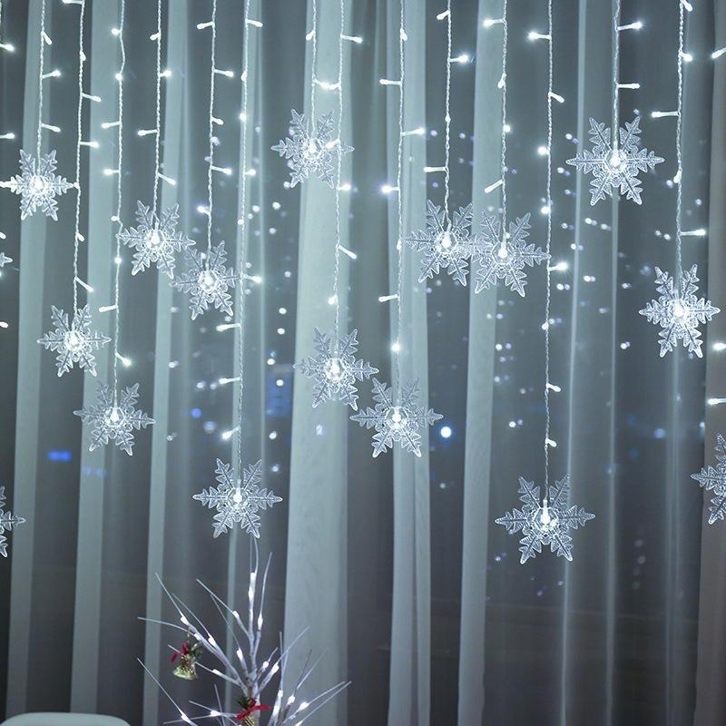Outdoor LED snowflake fairy lights illuminating gardens, patios, and festive events.