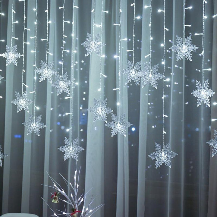 Outdoor LED snowflake fairy lights illuminating gardens, patios, and festive events.