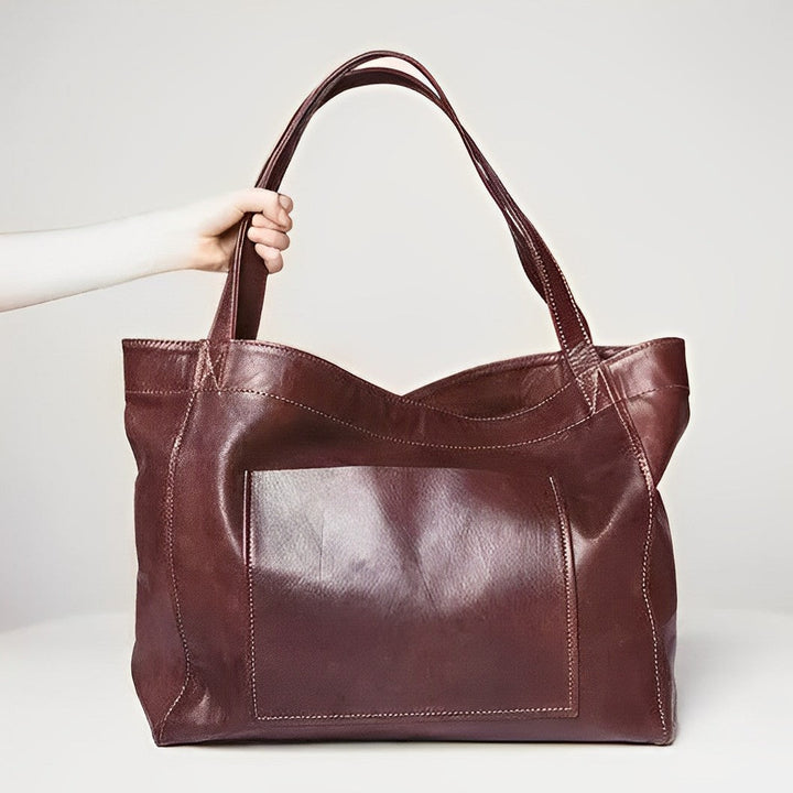 Stylish wine-colored vintage leather women's crossbody bag with adjustable strap, a durable & elegant accessory.