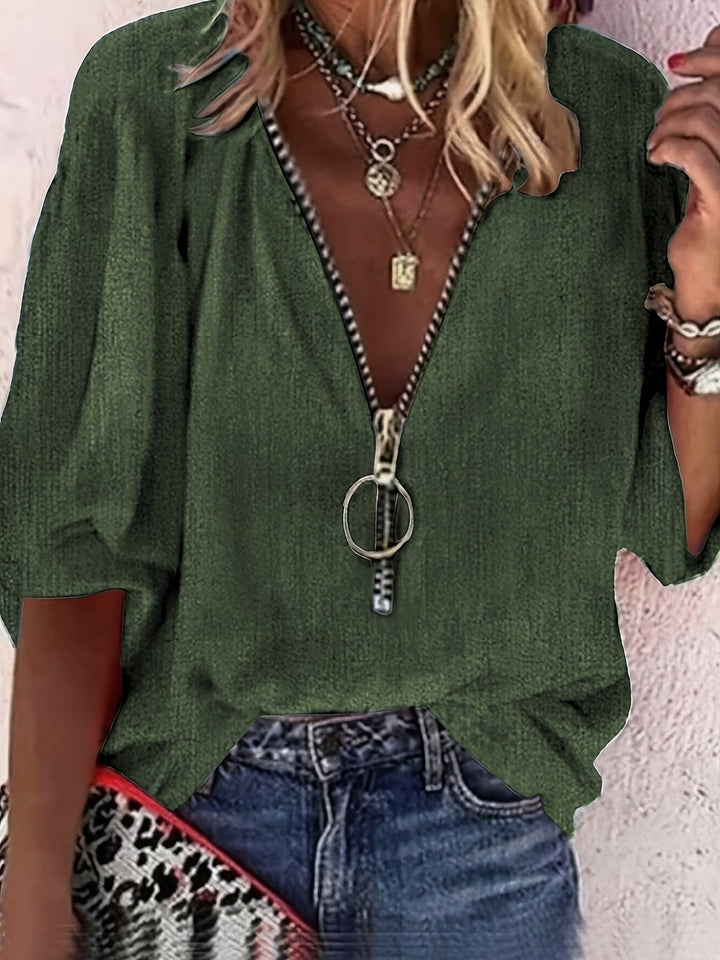 Stylish women's zip-front V-neck blouse with a relaxed fit. Fashionable three-quarter sleeve top for any occasion.