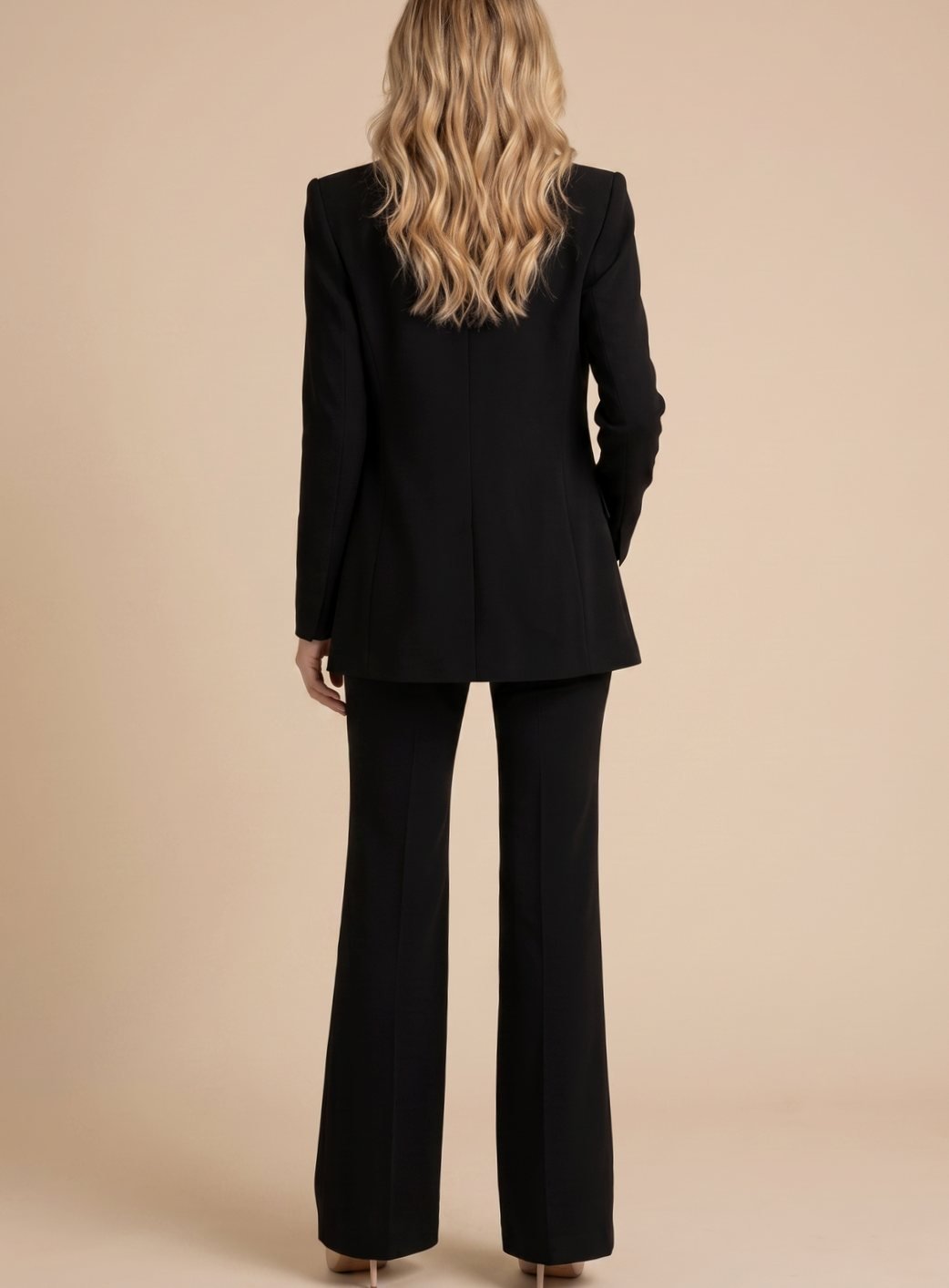 Fashionable women's elegant two-piece set with a chic blazer & sophisticated flared trousers, professional.