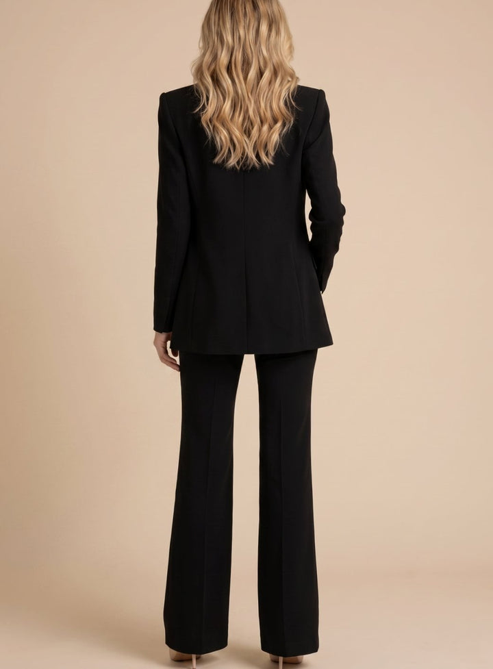 Fashionable women's elegant two-piece set with a chic blazer & sophisticated flared trousers, professional.