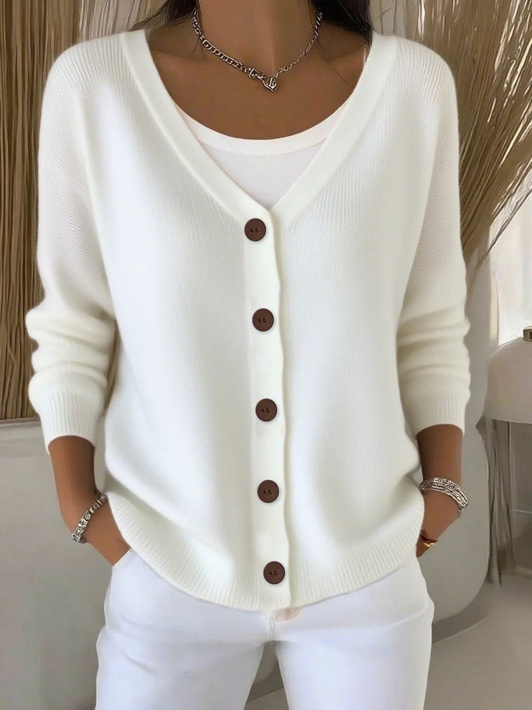 Elegant women's V-neck button-front knit cardigan, a long-sleeve sweater featuring a delicate knit design.