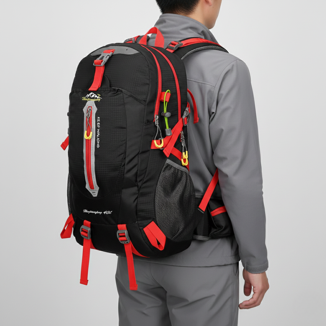 Unisex traveler wearing a 40L water resistant hiking backpack on an adventurous outdoor trail, carrying essential gear.