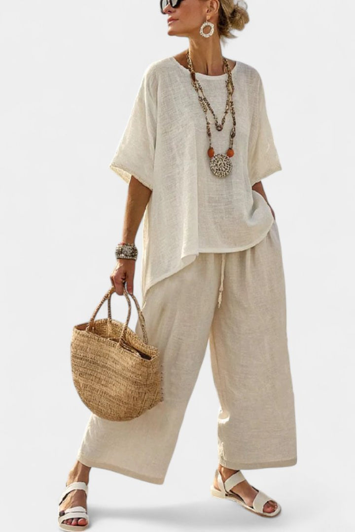 Women's comfortable asymmetrical two-piece set with relaxed fit top & wide-leg trousers, perfect for summer travel.