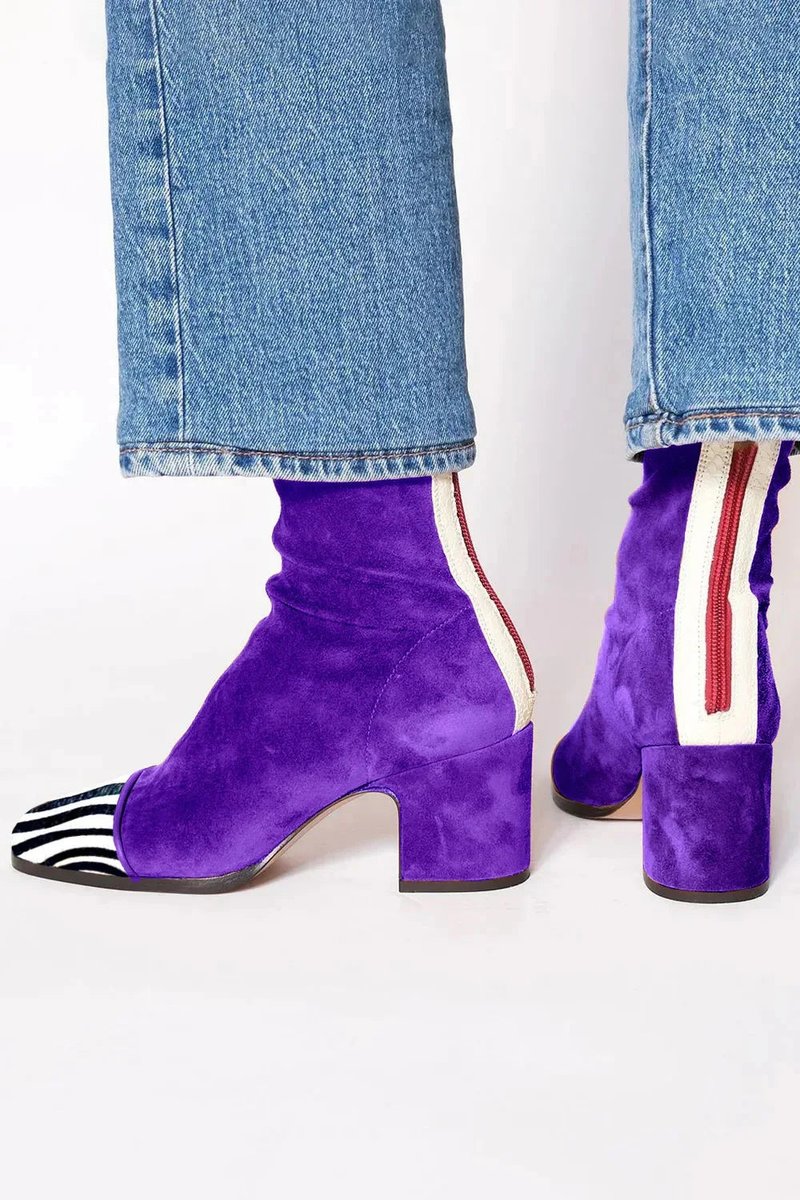 Modern women's ankle boots featuring a distinctive leopard print toe and a sturdy block heel.