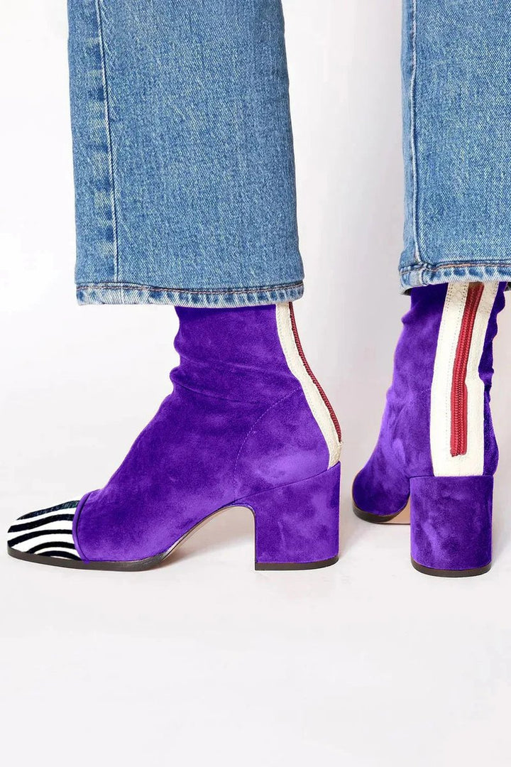 Modern women's ankle boots featuring a distinctive leopard print toe and a sturdy block heel.