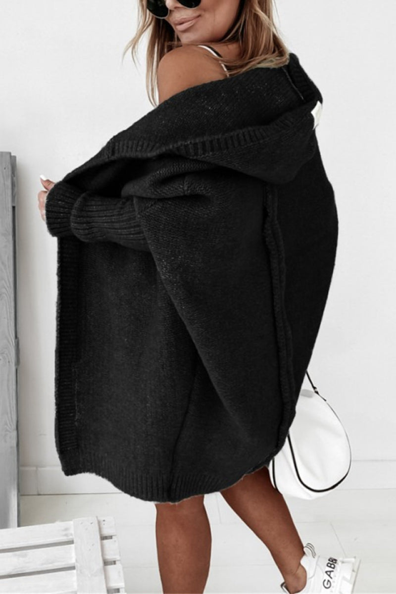 Cozy women's oversized knit cardigan with hood, perfect for casual layering in cool weather.