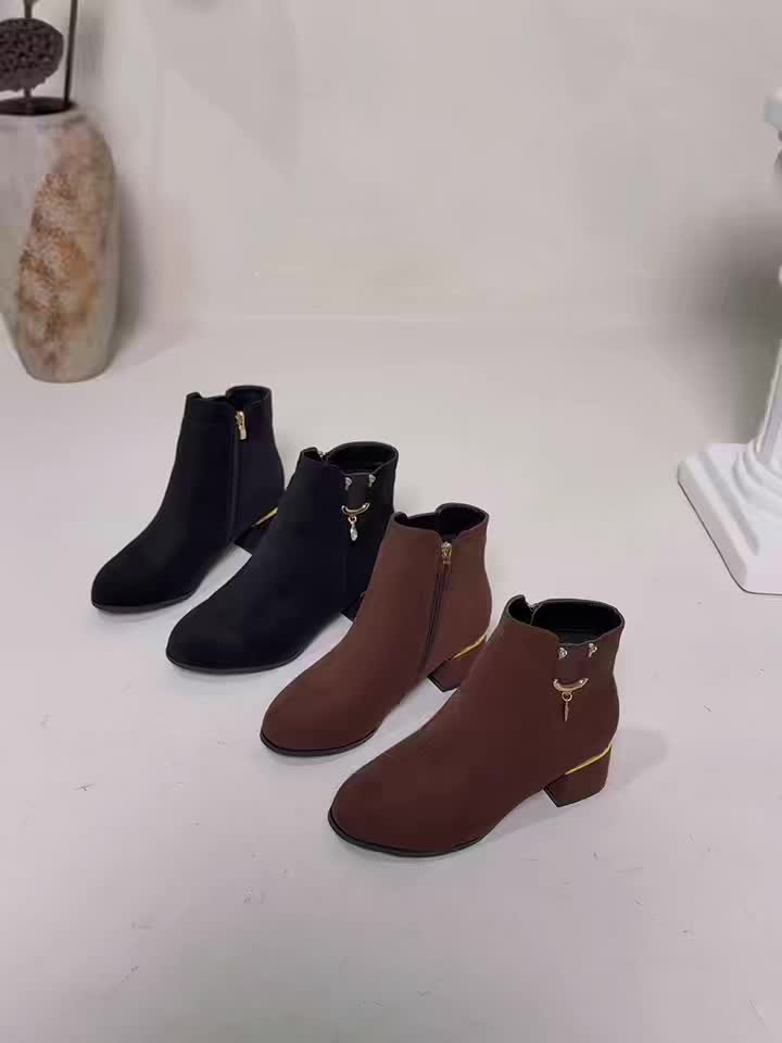 Close-up of rich brown women's Chelsea ankle boots, detailed with a fashionable block heel.