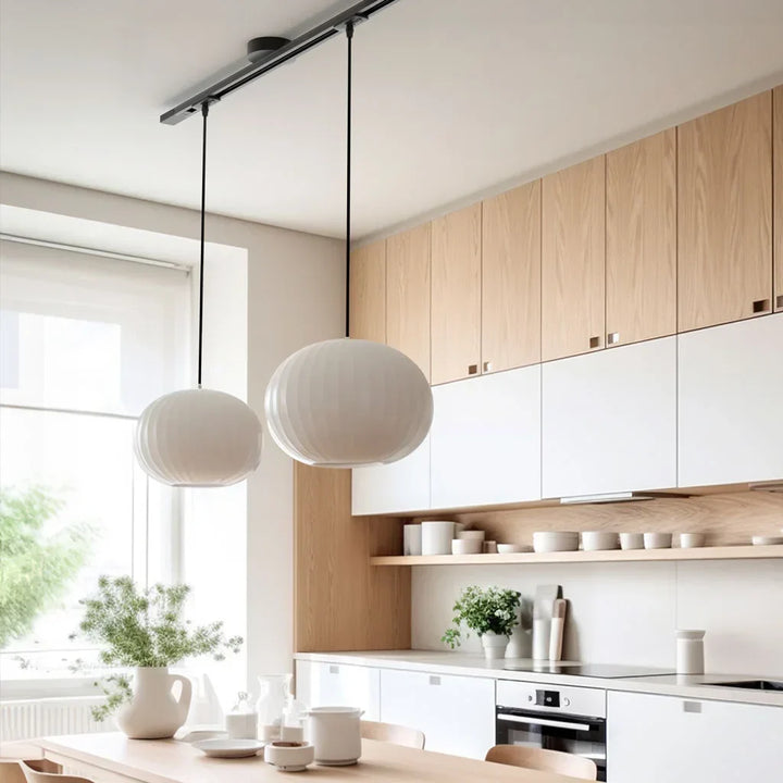 Black adjustable pendant light rail. Modern ceiling fixture for flexible home lighting.