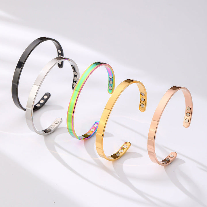 Sleek wide glossy stainless steel magnetic cuff bracelet. Unisex modern design, elegant accessory.