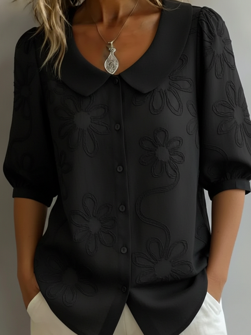 Stylish women's embroidered floral blouse with short sleeves. Elegant, relaxed fit top for everyday wear and summer chic.