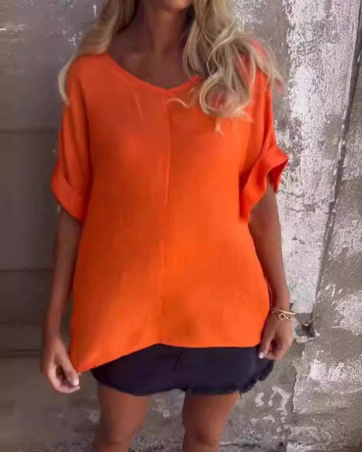 Women's V-neck short sleeve top with a relaxed, loose fit. Comfortable & versatile everyday essential for casual style.