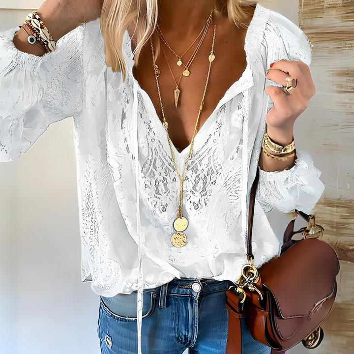 Effortless women's boho blouse, featuring v-neck & lace details, relaxed for comfort.