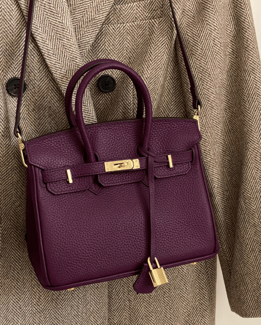 Versatile women's luxury handbag, embossed leather with radiant gold accents.