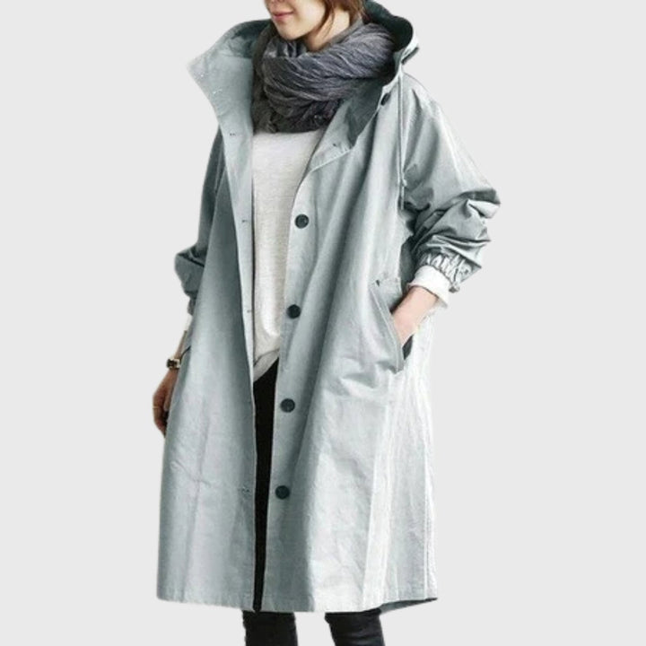 Water-resistant long hooded trench coat for women, offers weather protection for spring & fall outerwear.