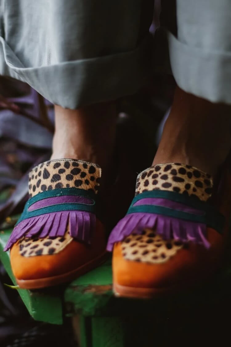 Women's animal-print slip-on loafers with stylish fringe, perfect for casual everyday wear.