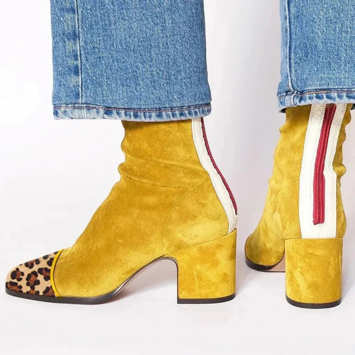 Women's block heel ankle boots with a stylish leopard print patterned toe, perfect for fashion.