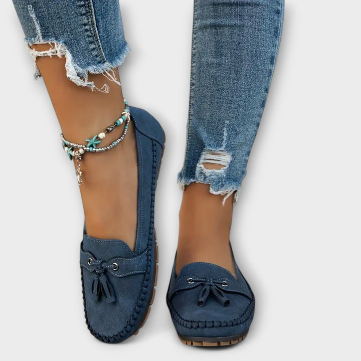 Classic black women's comfort loafers with orthopedic support. Ideal slip-on shoes for casual and professional settings.