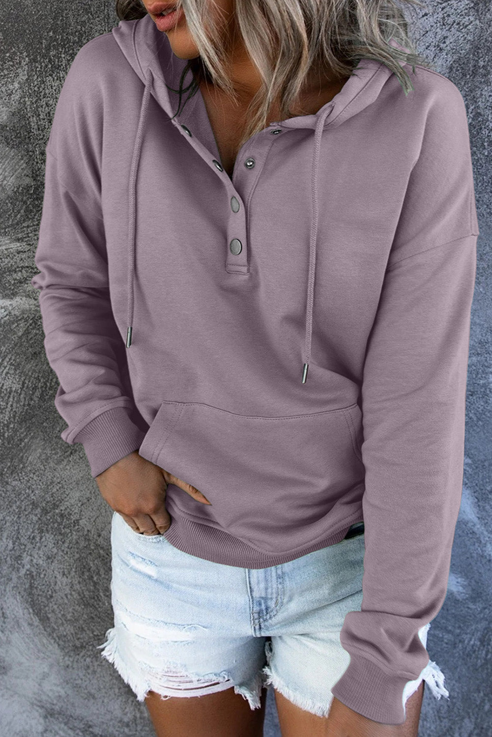 Close-up of the soft fabric on a women's cozy hooded sweater. Comfortable apparel.