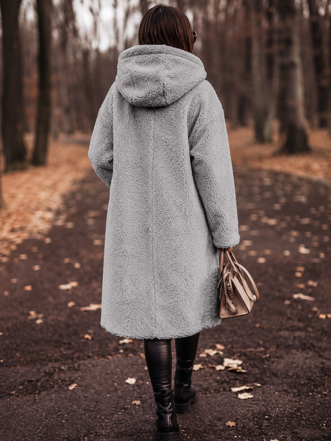 Stylish women's winter coat, hooded & elegant for cold weather and seasonal fashion.
