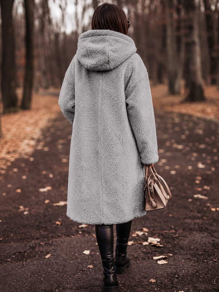 Stylish women's winter coat, hooded & elegant for cold weather and seasonal fashion.
