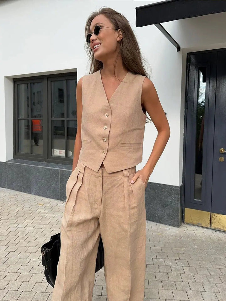 Full view of a woman wearing the comfortable, chic vest and pleated wide-leg pant set.