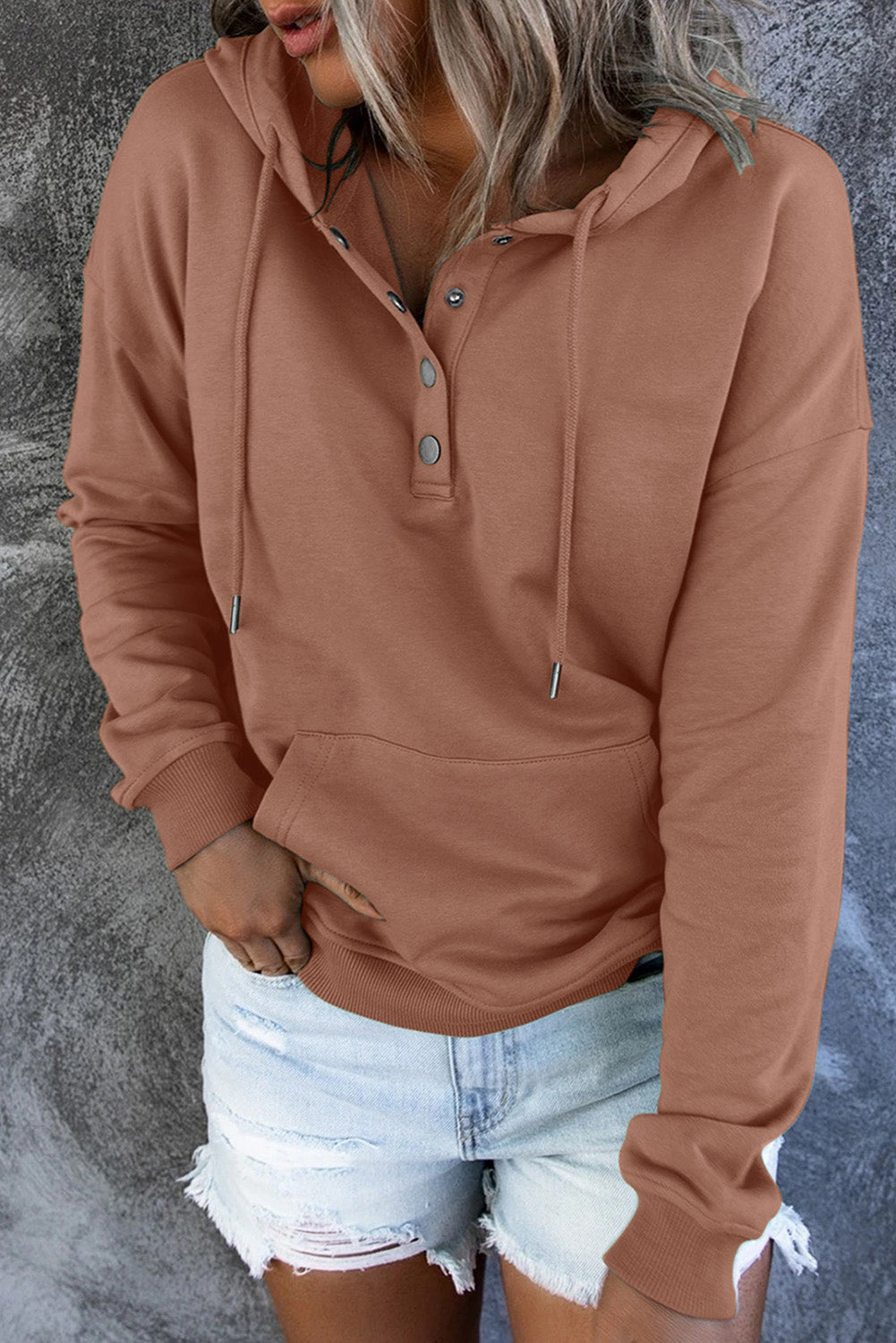 Front view of a women's relaxed fit hooded sweater. Comfortable & stylish everyday apparel.