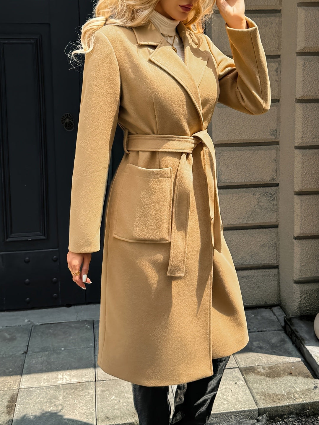 Sharp lapels on a women's classic trench coat. Tailored for a formal and elegant outerwear look.