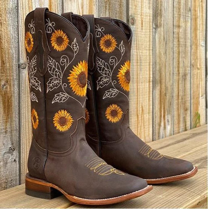 Comfortable women's western cowboy boots featuring vibrant sunflower embroidery and a wide calf design.