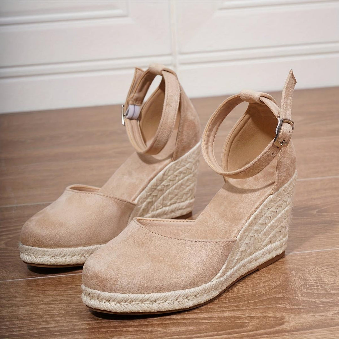 Women's wedge sandals with an adjustable ankle buckle strap. Casual, open-toe design for comfortable summer everyday wear.