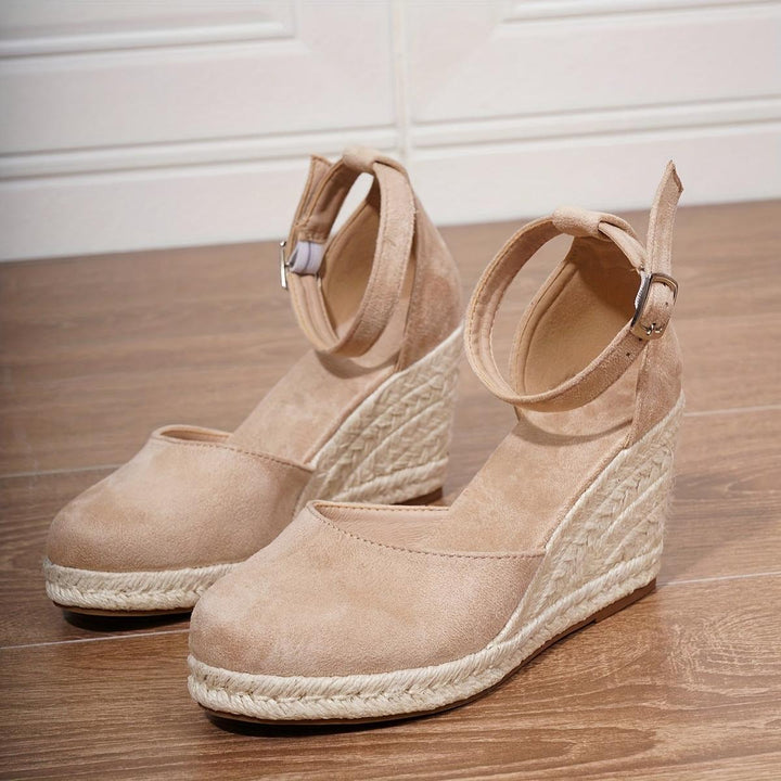 Women's wedge sandals with an adjustable ankle buckle strap. Casual, open-toe design for comfortable summer everyday wear.