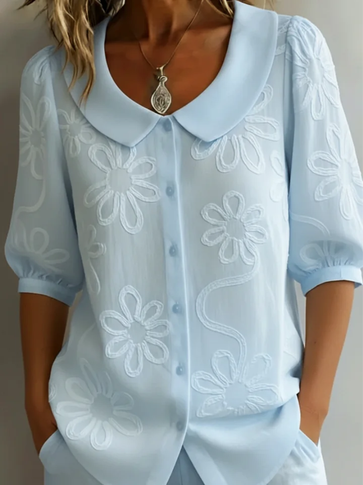 Women's stylish floral embroidered short sleeve blouse. Elegant and versatile round neck top for everyday casual or chic outfits.