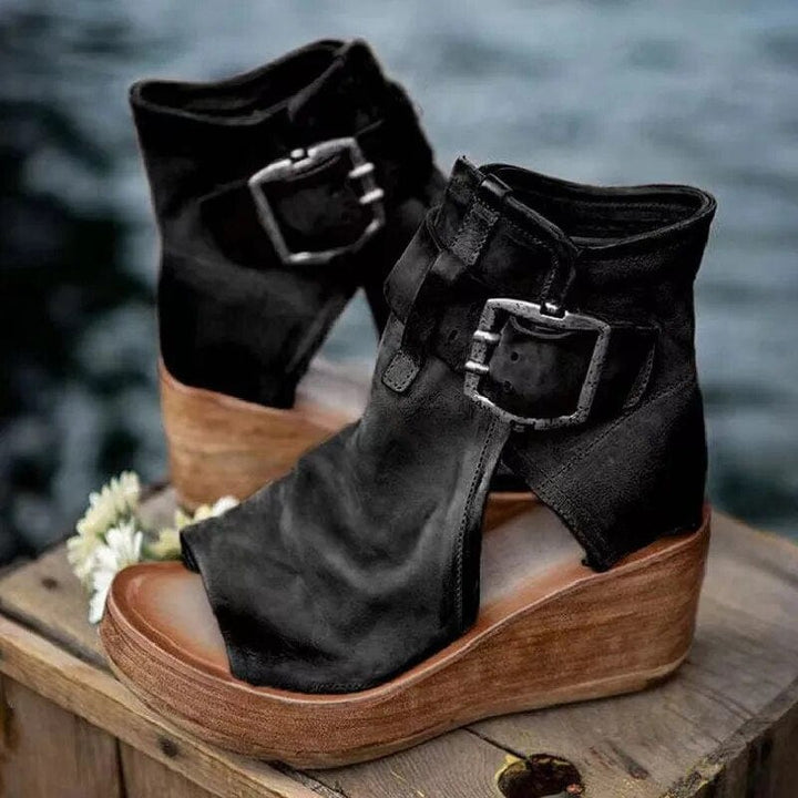 Comfortable women's open-toe wedge sandals with a distressed look & fashionable buckle details.