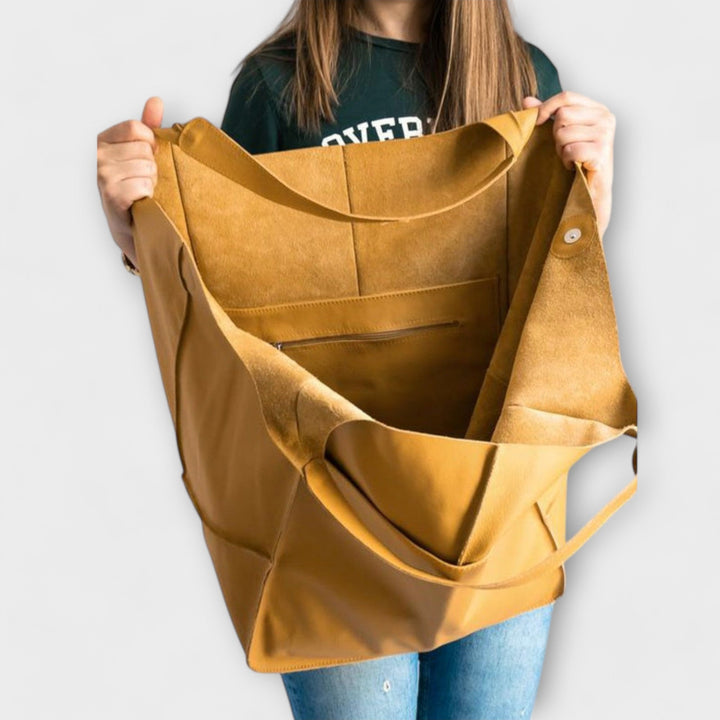 Chic oversized leather weekender duffel bag for women, combining style with travel utility.