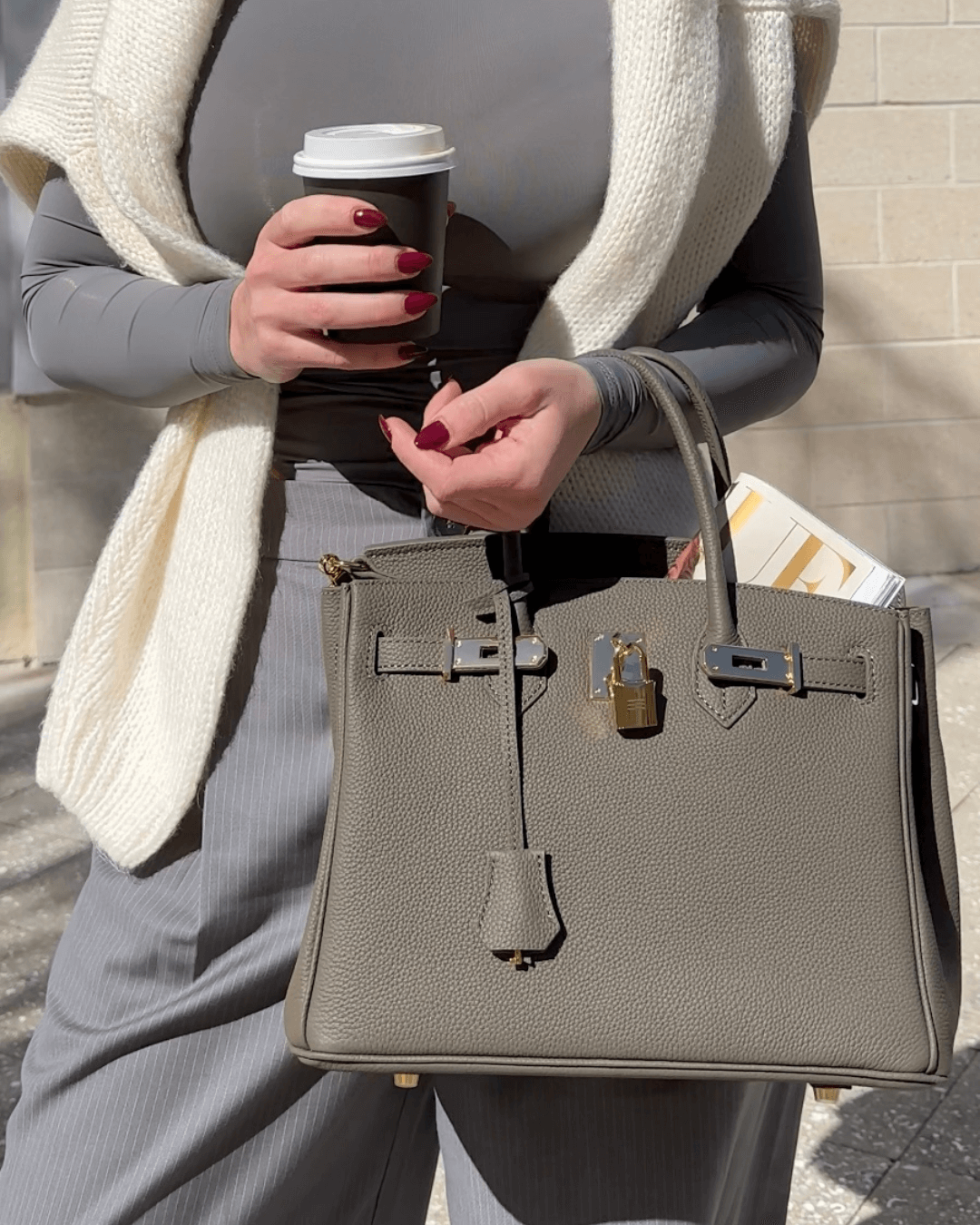 Sophisticated women's leather purse, embossed design, and elegant gold-tone details.