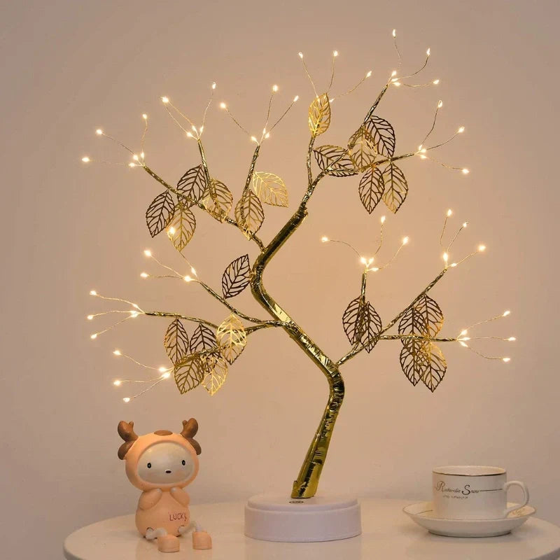 Golden leaf LED bonsai tree lamp emitting a soft warm white light. An elegant and decorative home accessory.