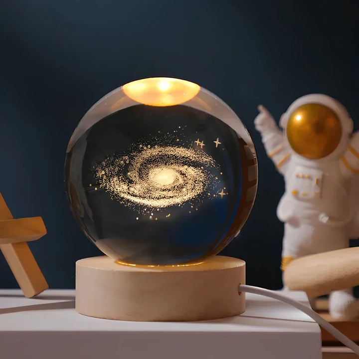 Stunning galaxy crystal ball LED lamp, casting a soft glow. Ideal night light for a unique room aesthetic.